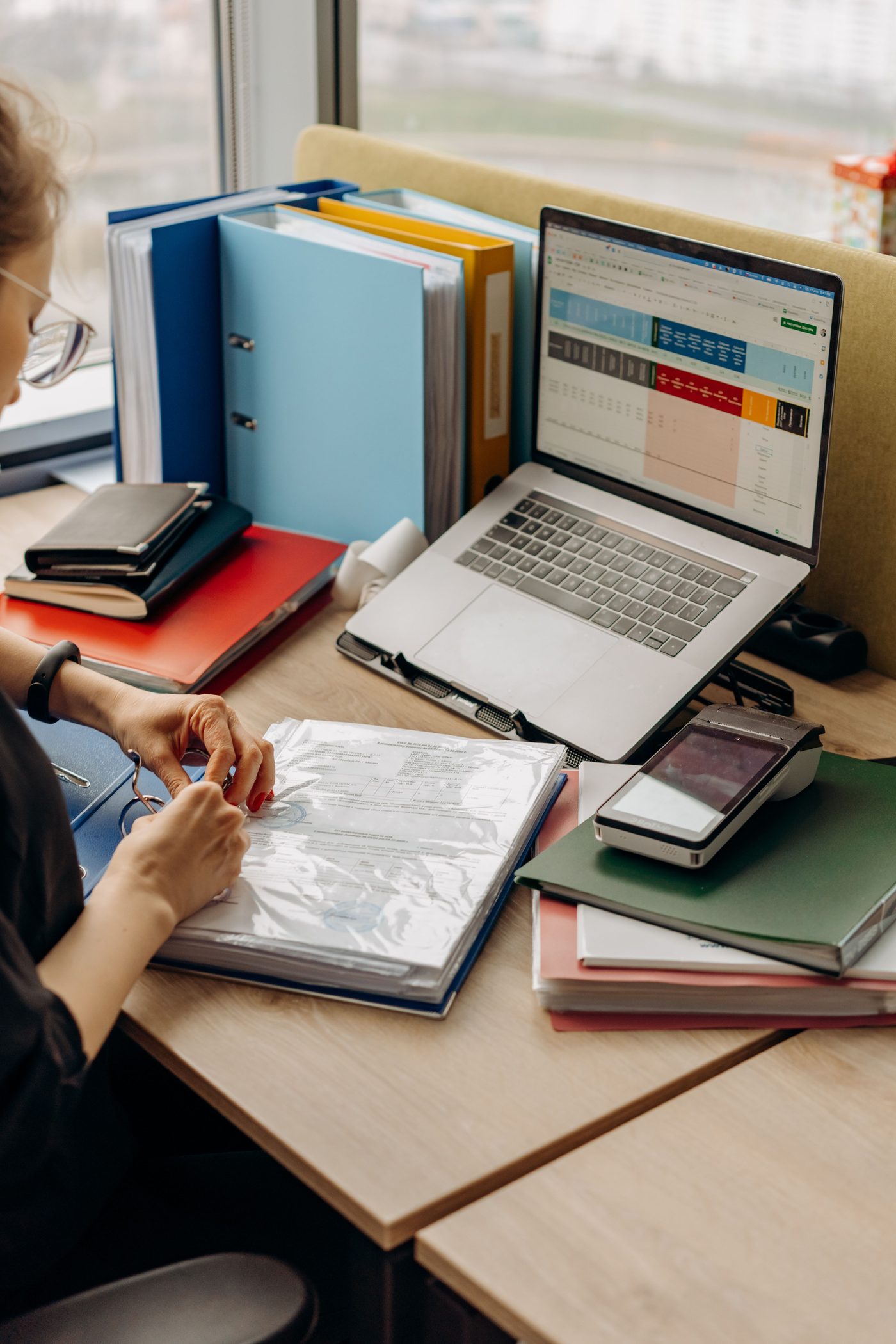 Professional reviewing documents at a workstation